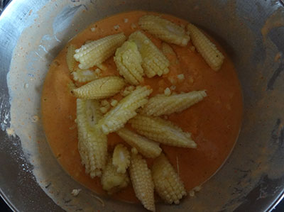 Sliced baby corns in batter for baby corn manchurian
