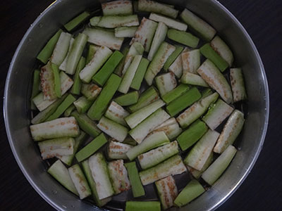 chop brinjal and onion for badanekayi palya or brinjal onion stir fry