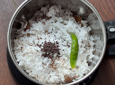 grinding coconut, green chillies and mustard for bendekai mosaru sasive recipe