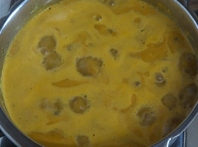 boiling kumbalakai huli or ash gourd sambar
