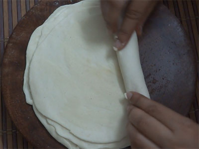 rolling the chapathis chiroti