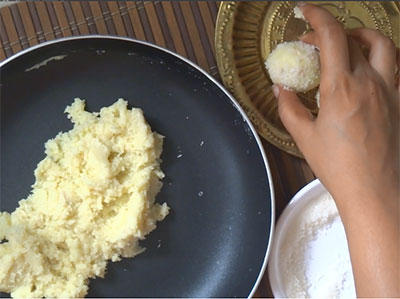 shaping the coconut and milk powder ladoo or laddu