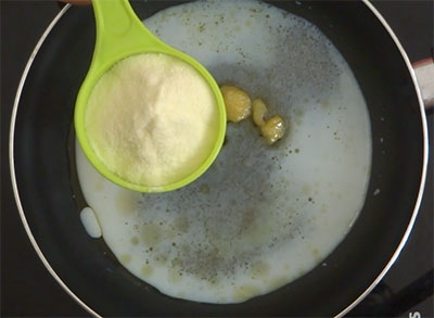 stirring milk and milk powder for coconut and milk powder ladoo or laddu
