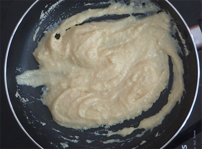 stirring milk, sugar and milk powder for coconut and milk powder ladoo or laddu