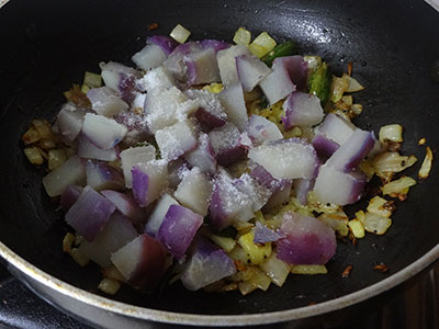 Chopped sweet potato and salt for genasina palya or sweet potato stir fry
