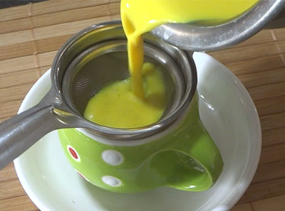 straining golden milk or turmeric milk recipe