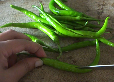 slitting green chillies for green chilli fry recipe
