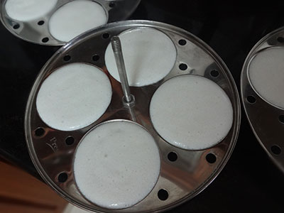 pour the batter in idli moulds for soft idli using idli rice