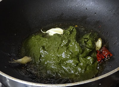 making kesuvina ele chutney or taro leaves chutney