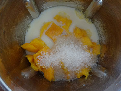 blend mango and milk for mango popsicles