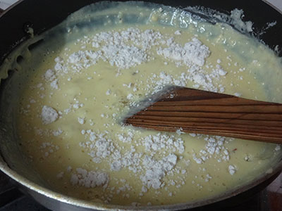 stirring milk and milk powder for milk peda or doodh peda