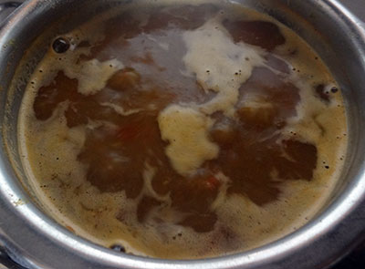 boiling menasina saaru or pepper rasam