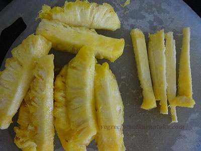 chopping pineapple for pineaple menaskai or ananas gojju