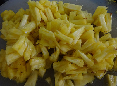 cutting pineapple for pineapple curry or ananas gojju