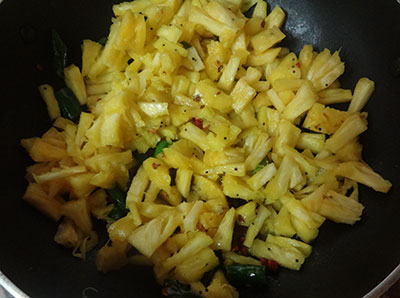 frying and cooking bitter gourd for pineapple curry or ananas gojju