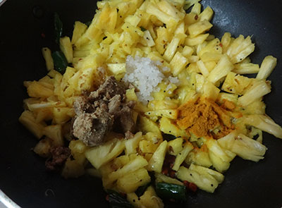 frying and cooking pineapple for pineapple curry or ananas gojju