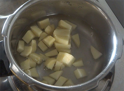 cooking potatoes for potato rasam or alugadde saaru
