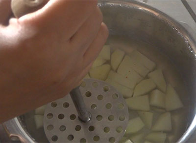 mashing potato for potato rasam or alugadde saaru