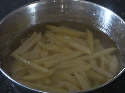 chopped potatoes in water for potato upkari or batata talasani recipe
