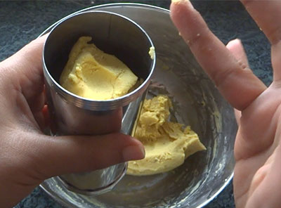 filling dough in the mould for ribbon pakoda recipe