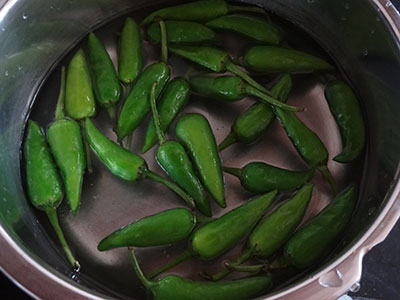 cleaning green chilies for sandige menasu or majjige menasu