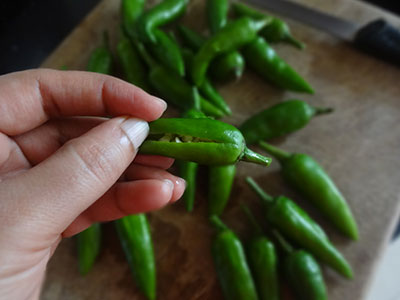 slit in the green chili for sandige menasu or majjige menasu