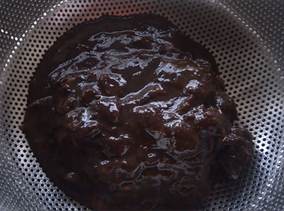 straining the tamarind pulp for home made tamarind paste recipe
