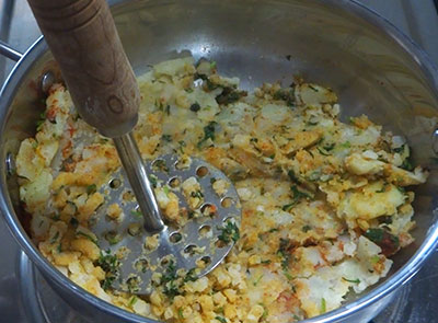 mashing potato and spices for no stuffing aloo paratha recipe