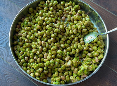 frying spice coated peanuts for chintamani kadalebeeja or kadlekai recipe