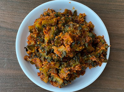 making hagalakayi palya or bitter gourd stir fry