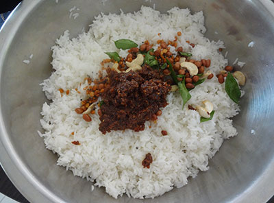 mixing puliyogare or tamarind rice